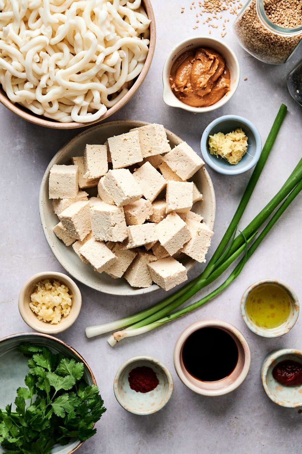 Flat lay of cooking ingredients arranged on a light surface.