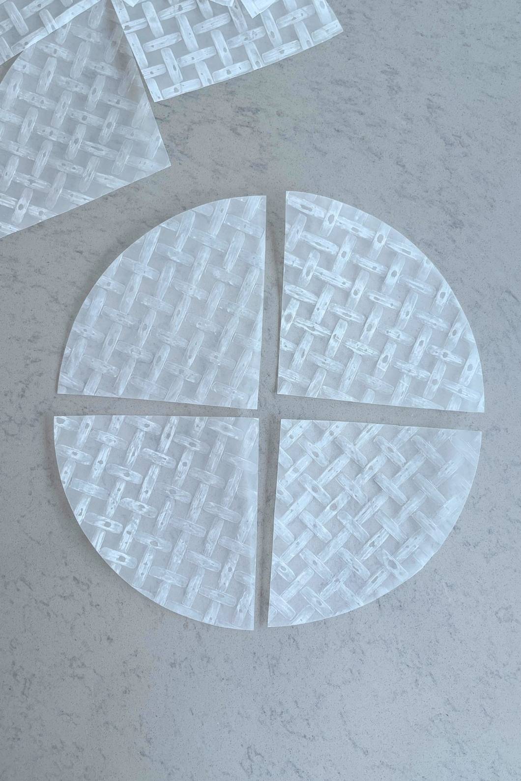 Quartered rice paper sheets arranged flat on a surface.