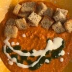 Tomato soup with croutons, basil oil, and yogurt swirl.