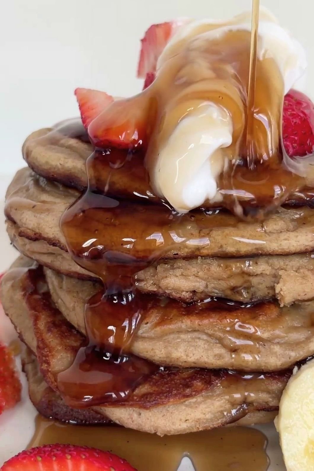 Maple syrup drizzled over banana pancakes.