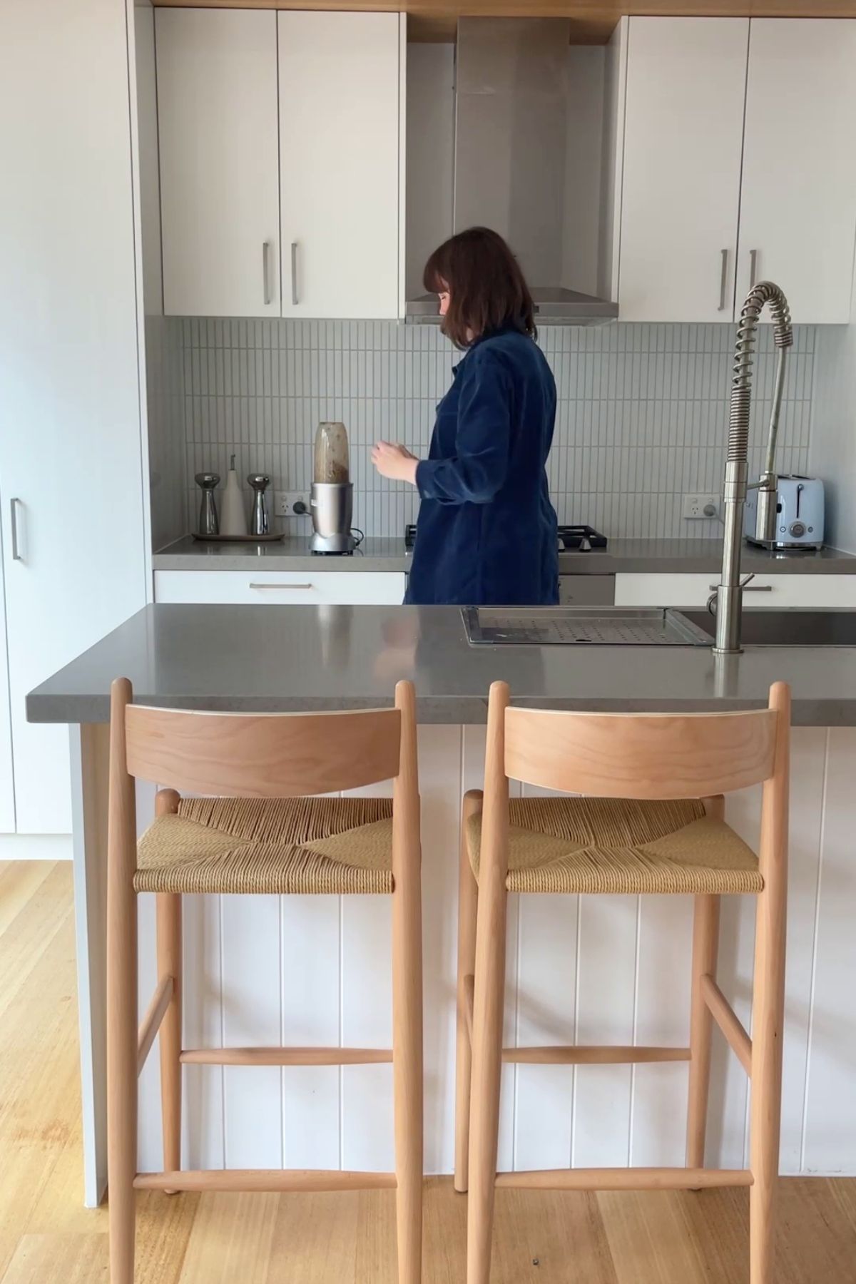Person blending mushroom pâté mixture in a small bullet blender on a modern kitchen counter.