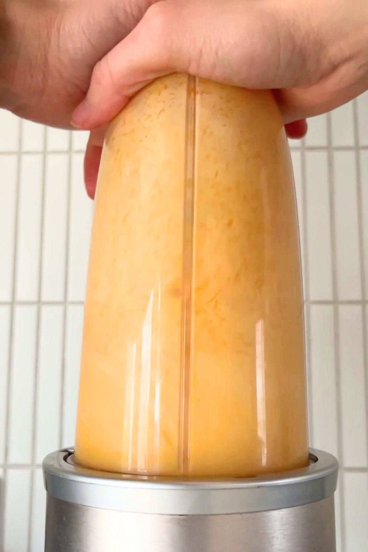 Blending steamed pumpkin with soy milk, vinegar, and vanilla to create a smooth, creamy plant-based buttermilk mixture.