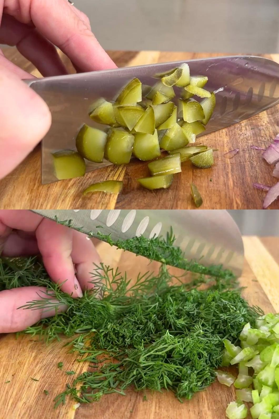 Chopping pickles and dill on board.