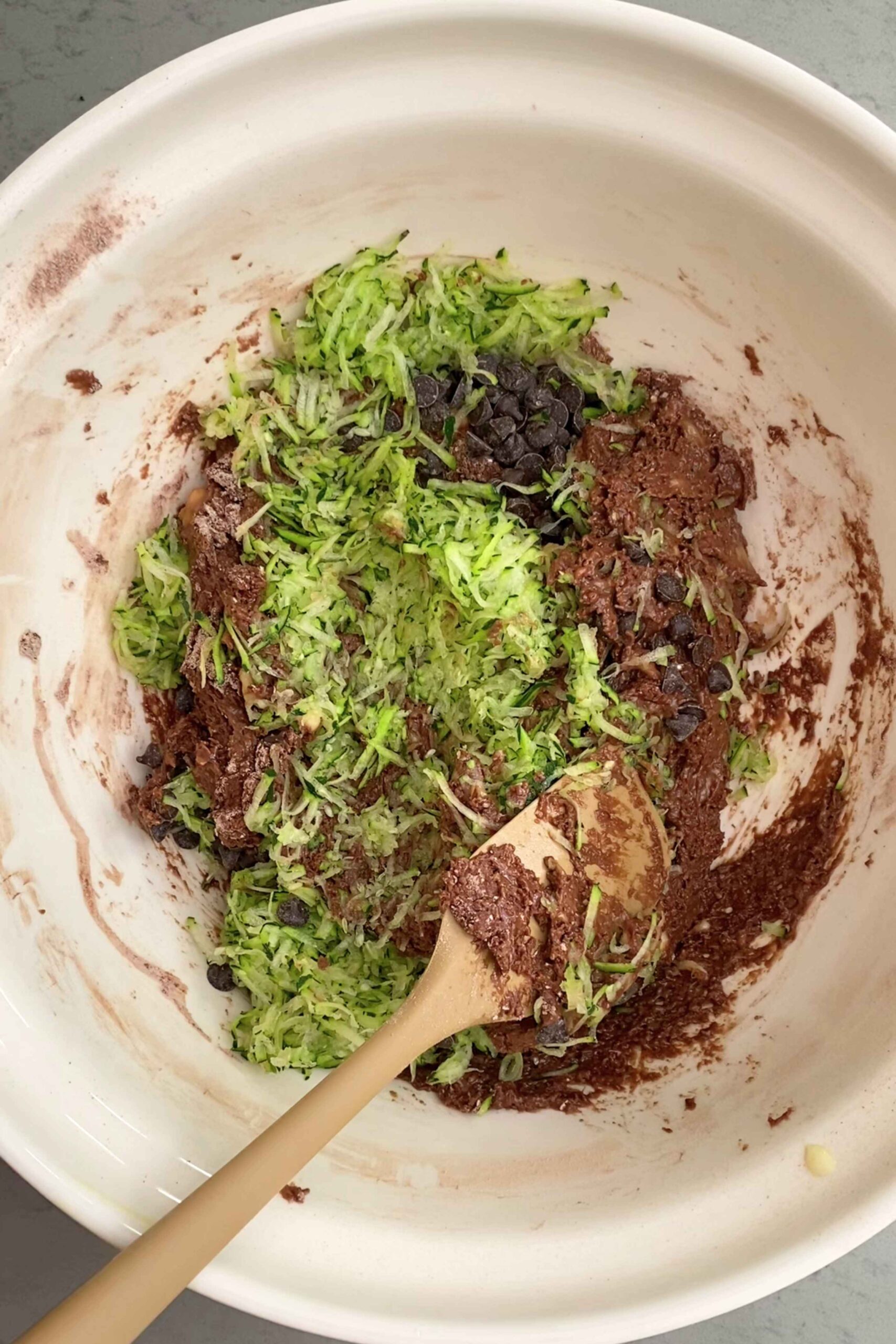 Chocolate batter folded with bright green shredded zucchini and dark chips.