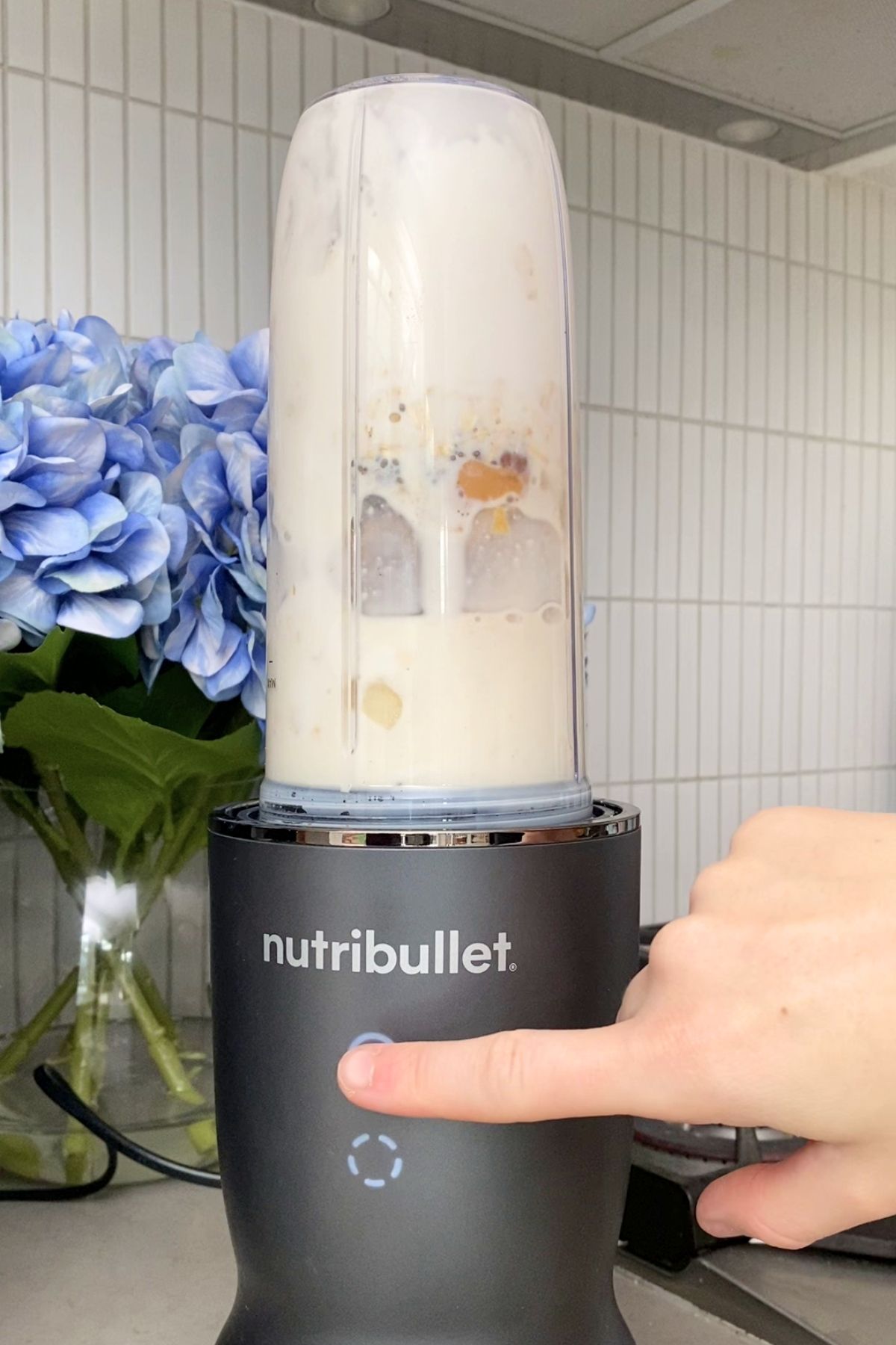 Blender cup inverted on nutribullet base awaiting blending.