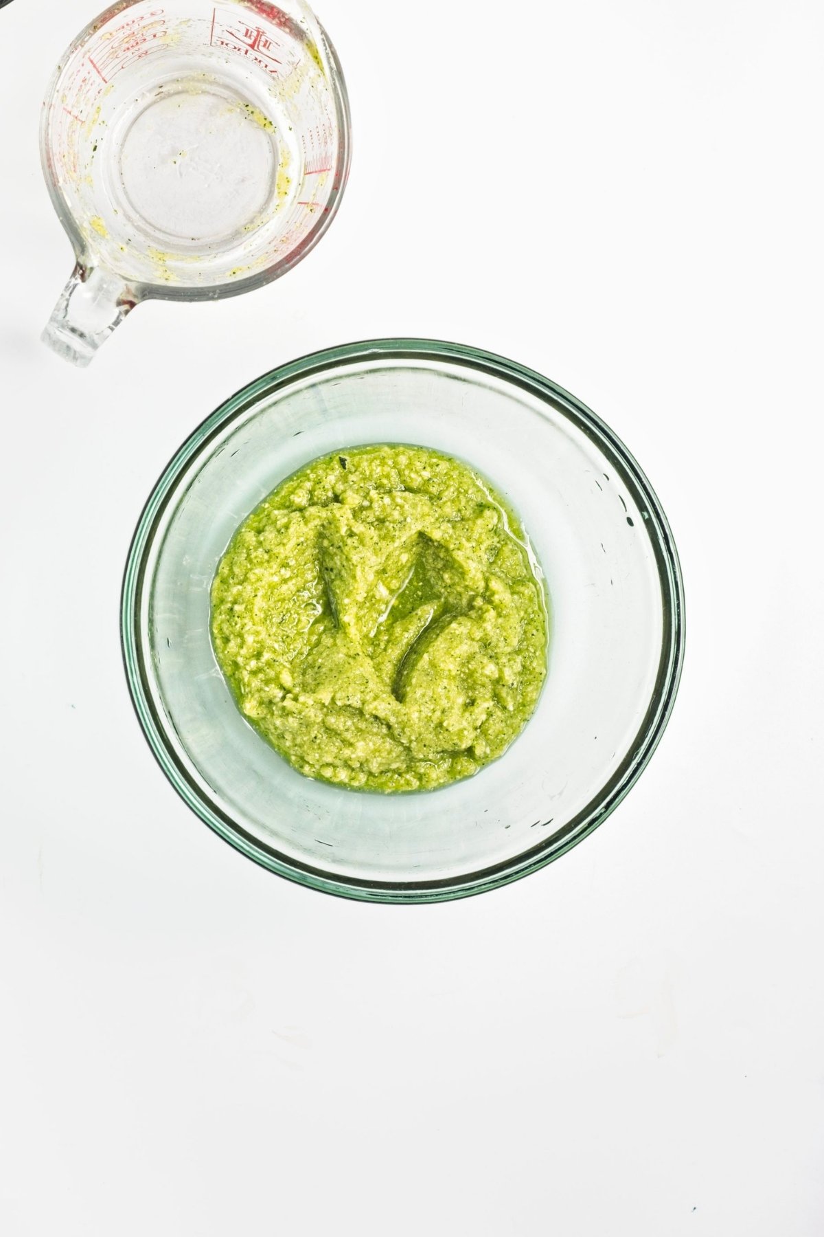 Green zucchini puree in a glass bowl.