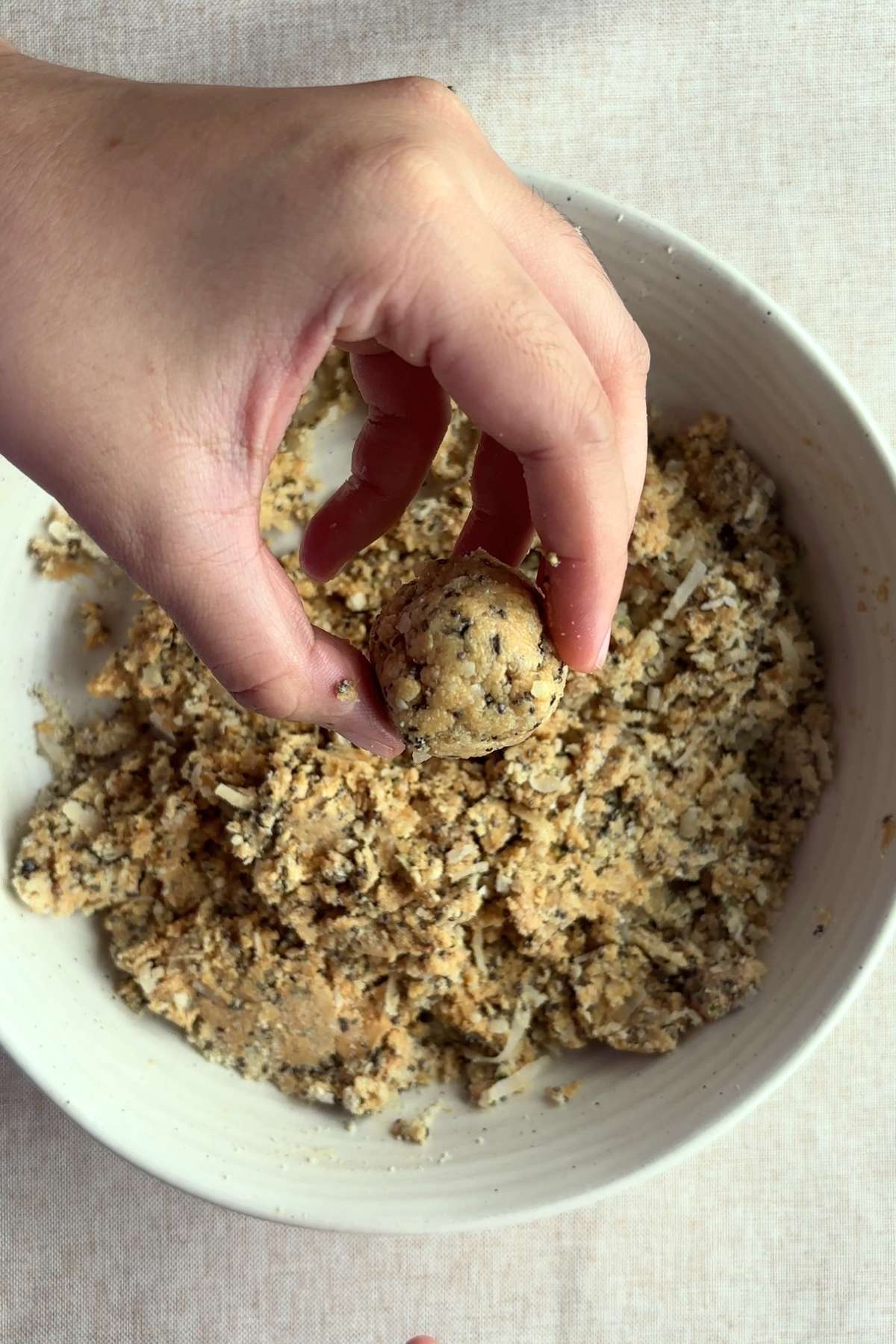 Hand rolling the dough into a small ball.