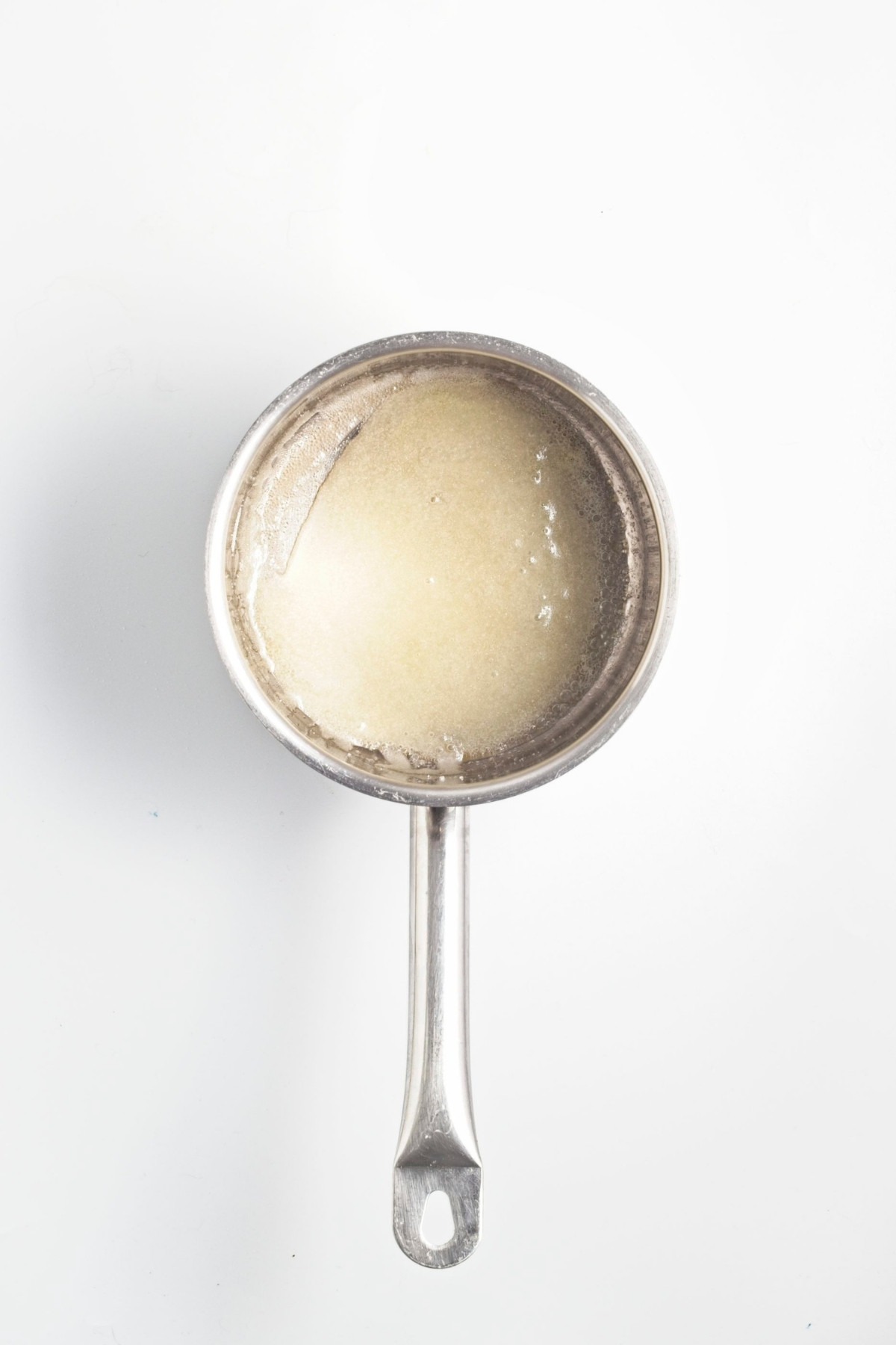 Sugar and butter melting together in a saucepan for brittle.