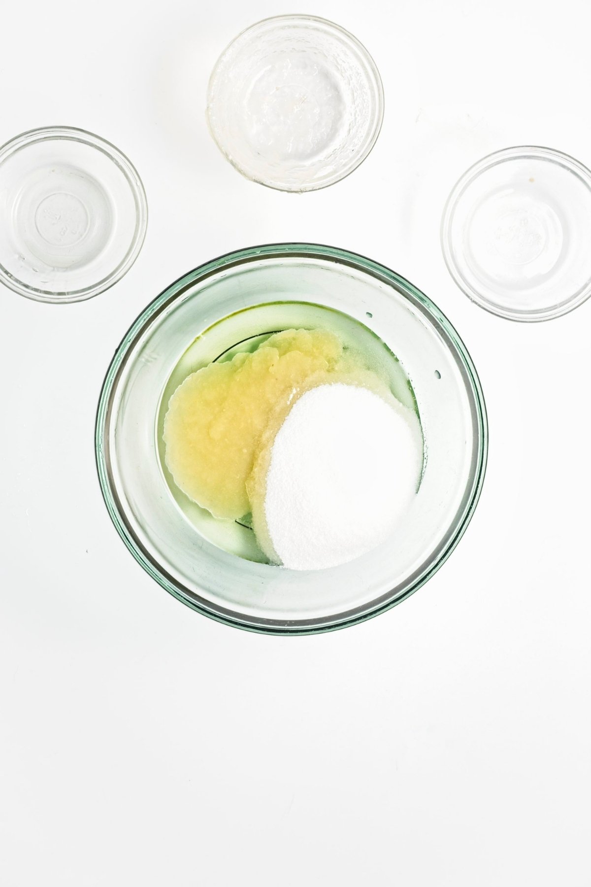 Bowl with applesauce and granulated sugar side by side.