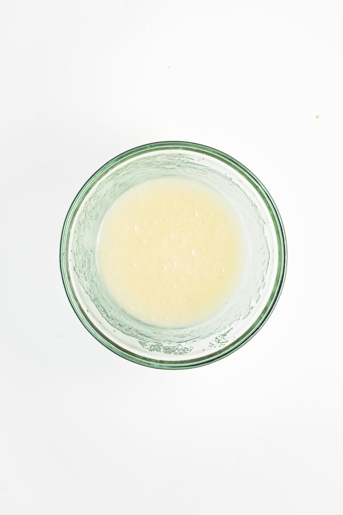 Bowl of wet ingredients whisked into a smooth mixture.