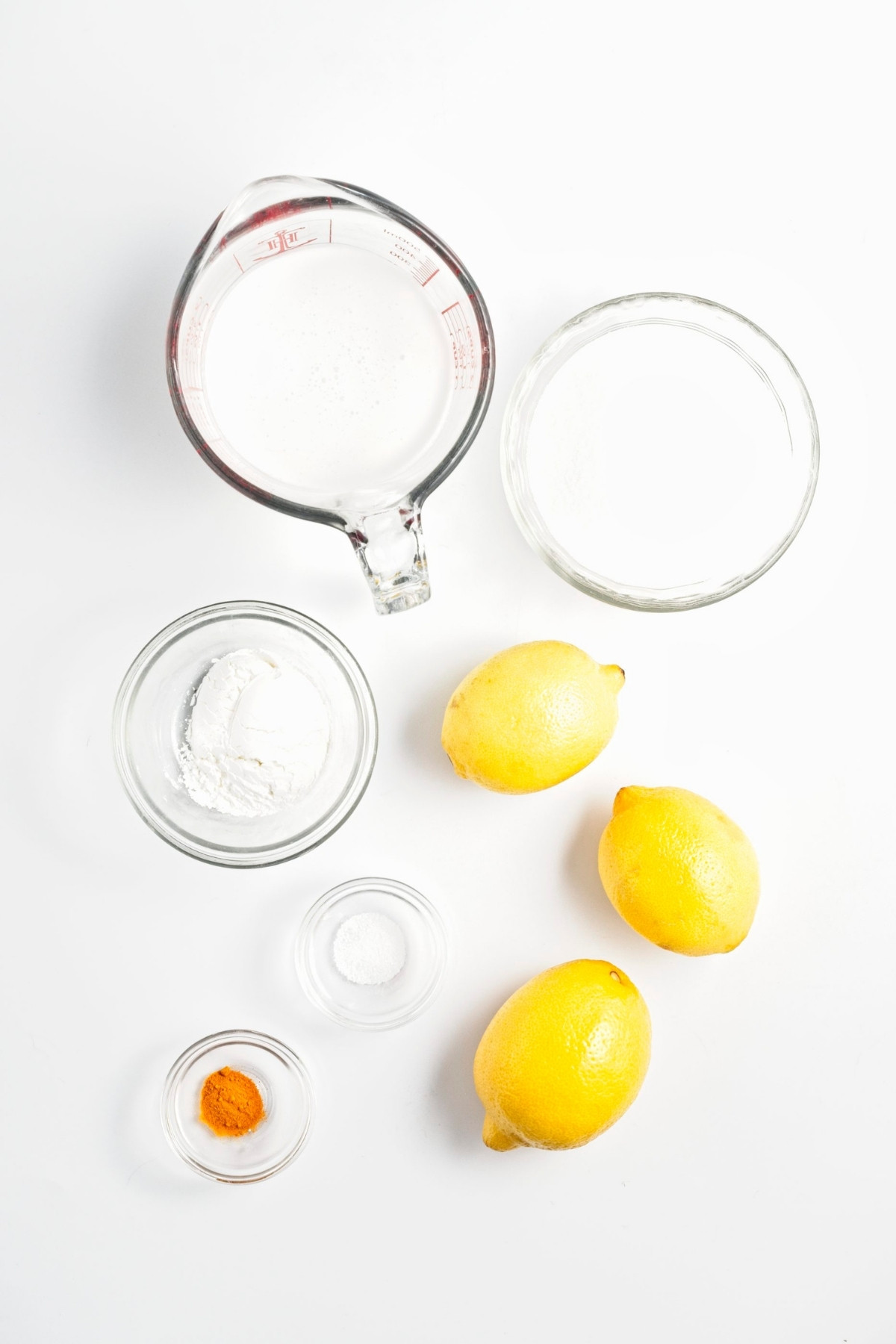 Lemons, sugar, cornstarch, salt, turmeric, and coconut milk in small bowls.