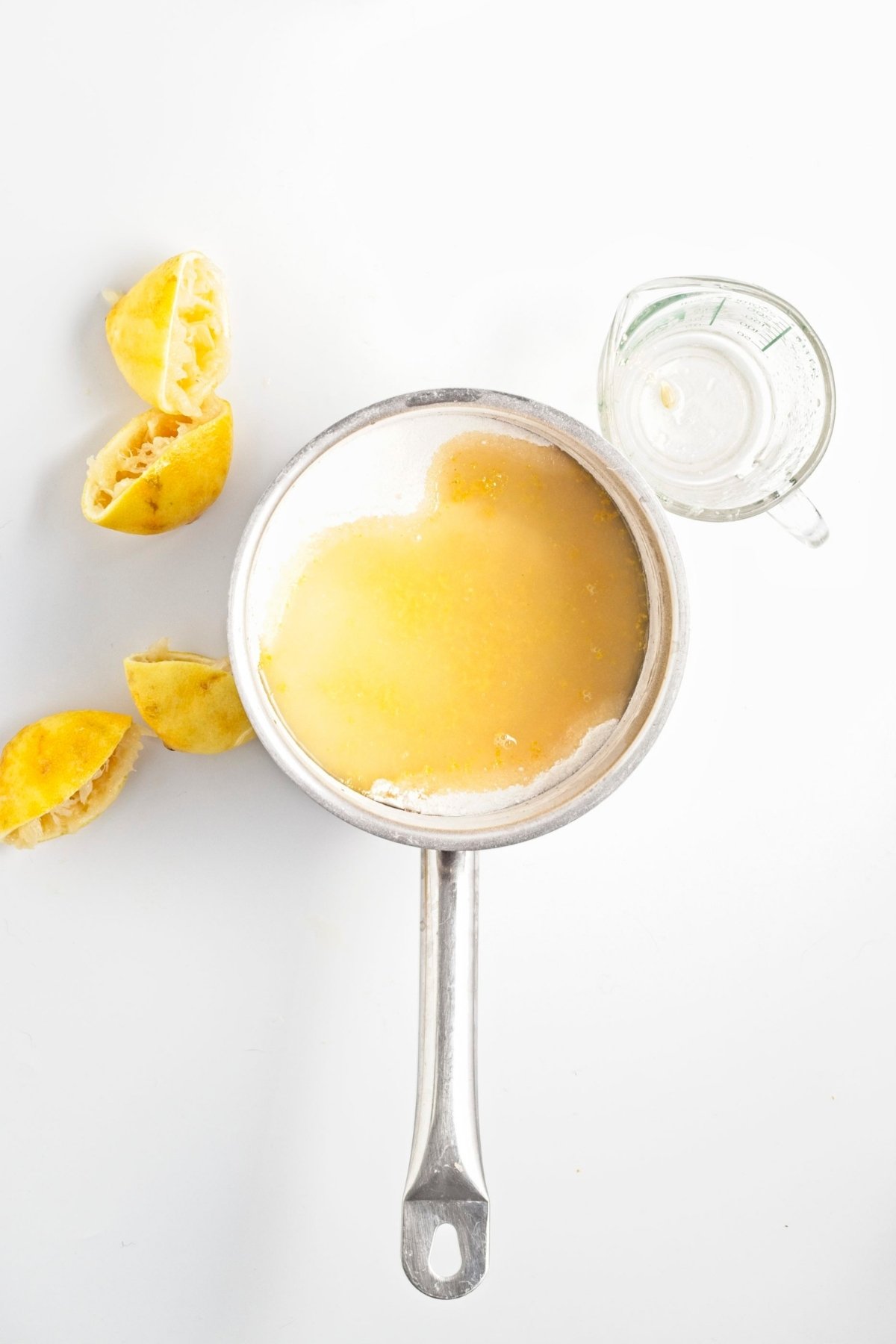 Saucepan with sugar mixture and freshly squeezed lemon juice.