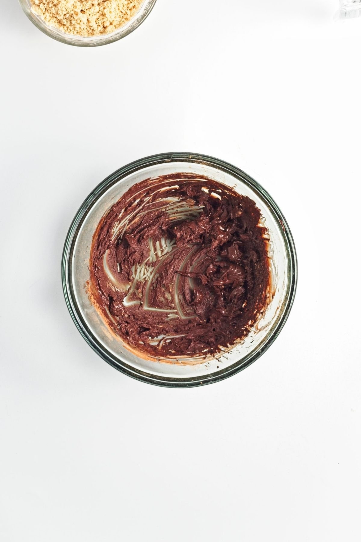 Thick chocolate batter in a glass bowl.