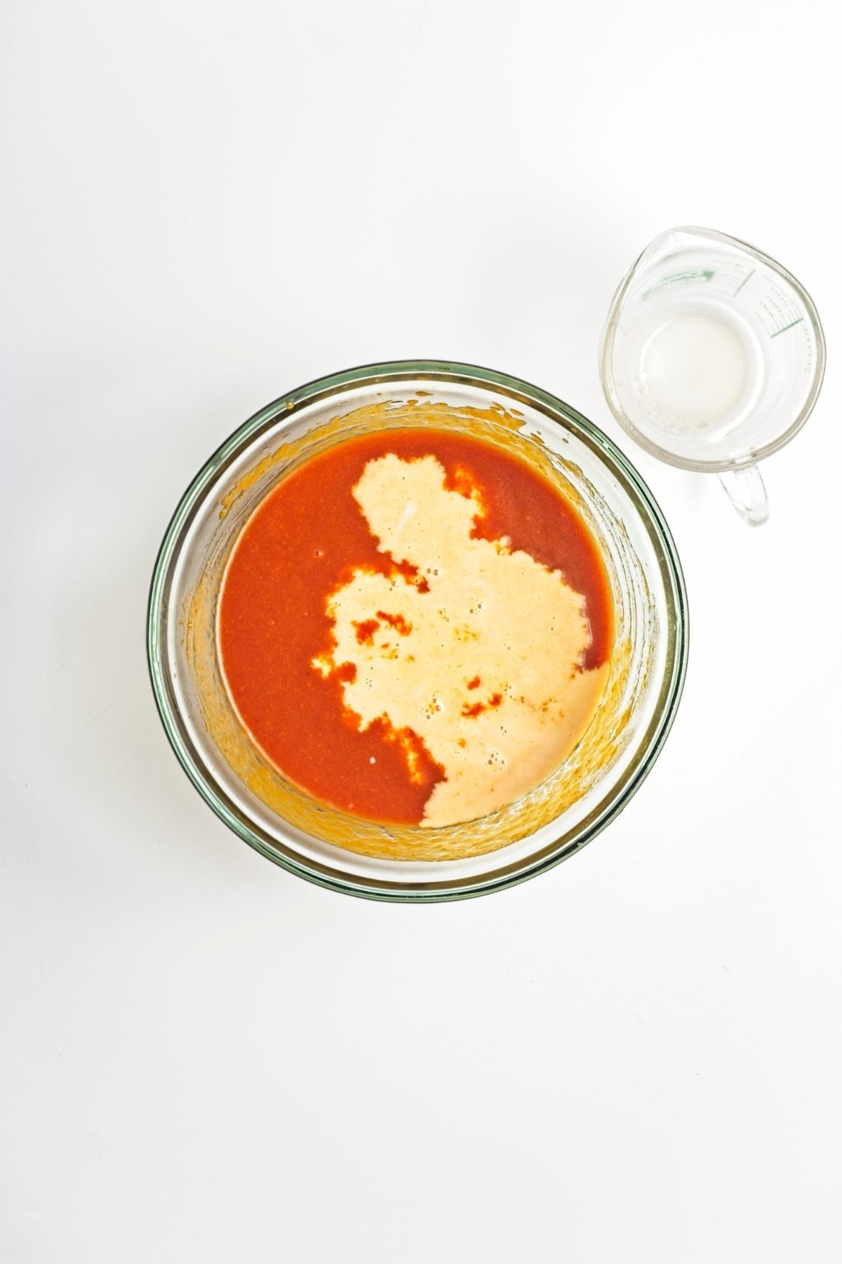 Pumpkin mixture with milk being combined in a bowl.