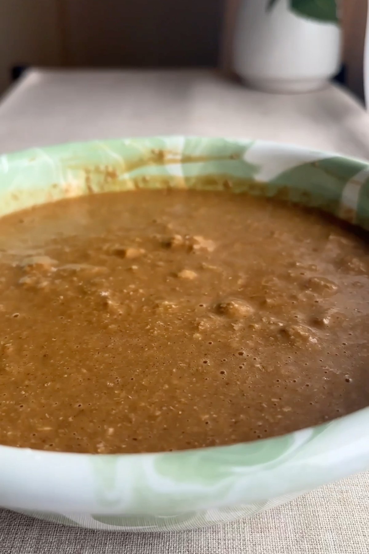Thick muffin batter resting in a green marbled bowl.
