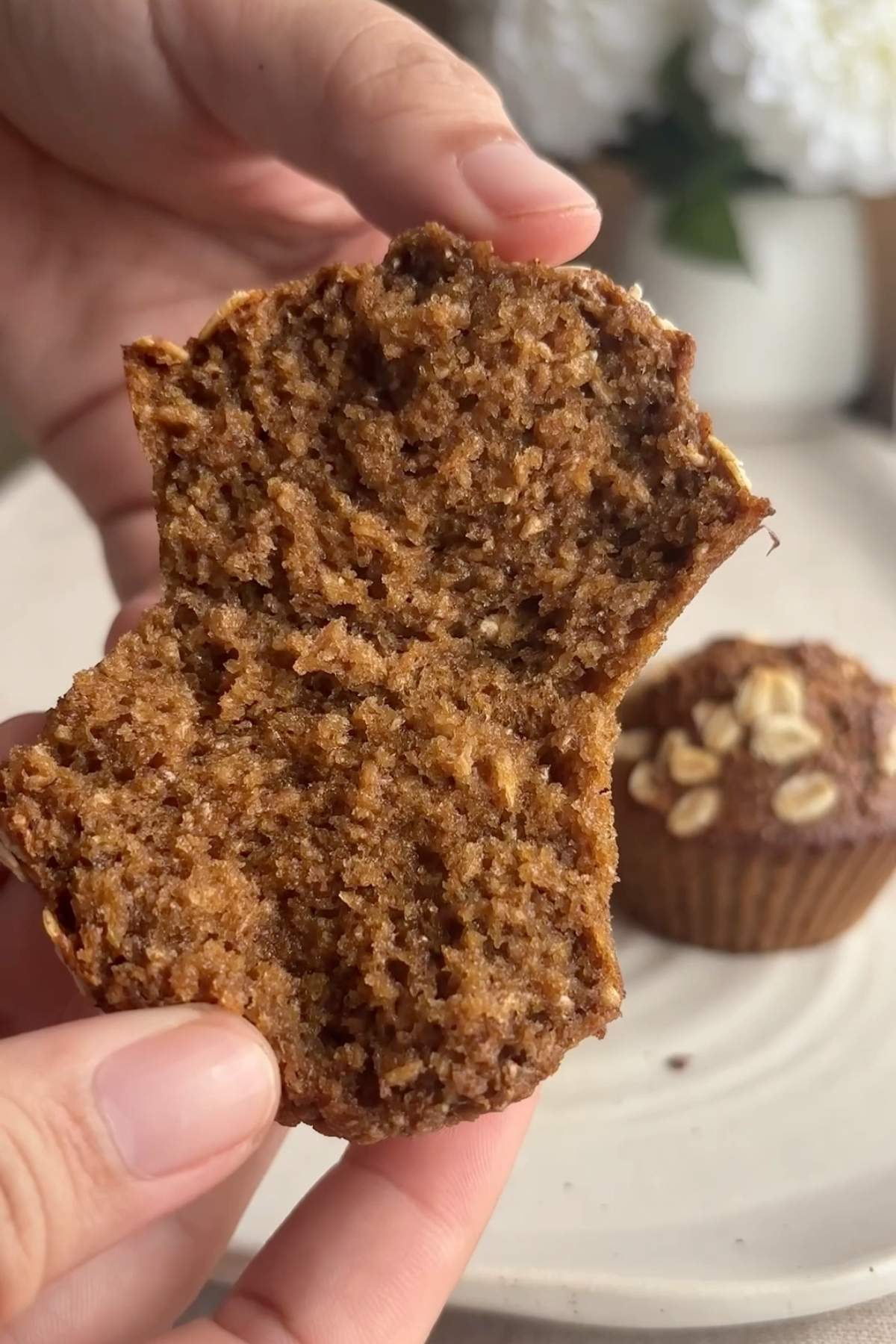 Muffin torn in half showing fluffy texture.
