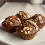 Plate of bran muffins topped with oats.
