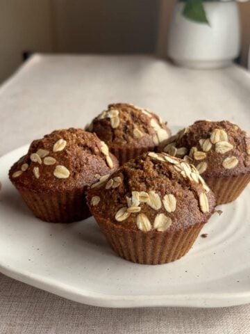 Plate of bran muffins topped with oats.