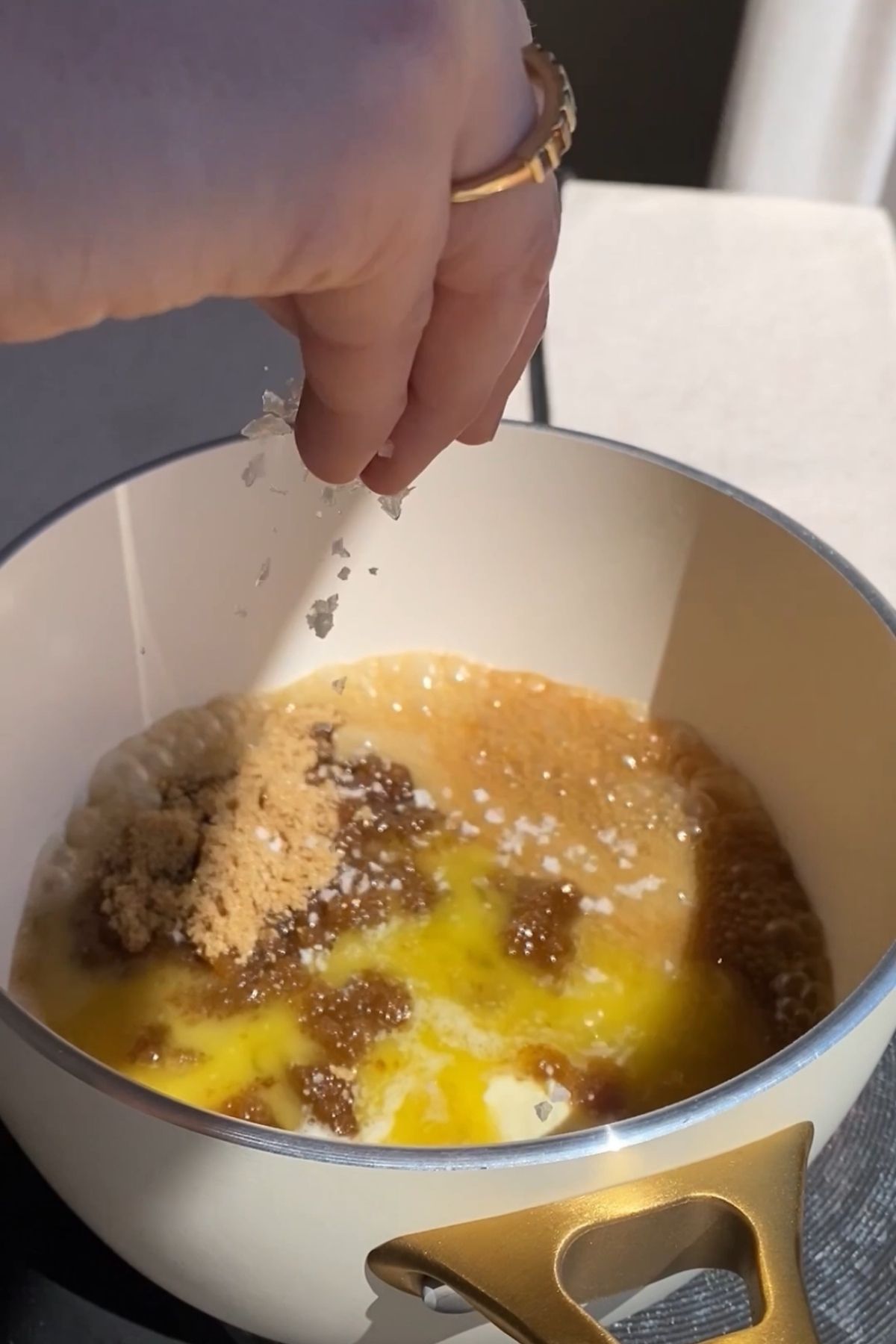 Brown sugar and melted butter with ground spices being mixed together in a bowl.