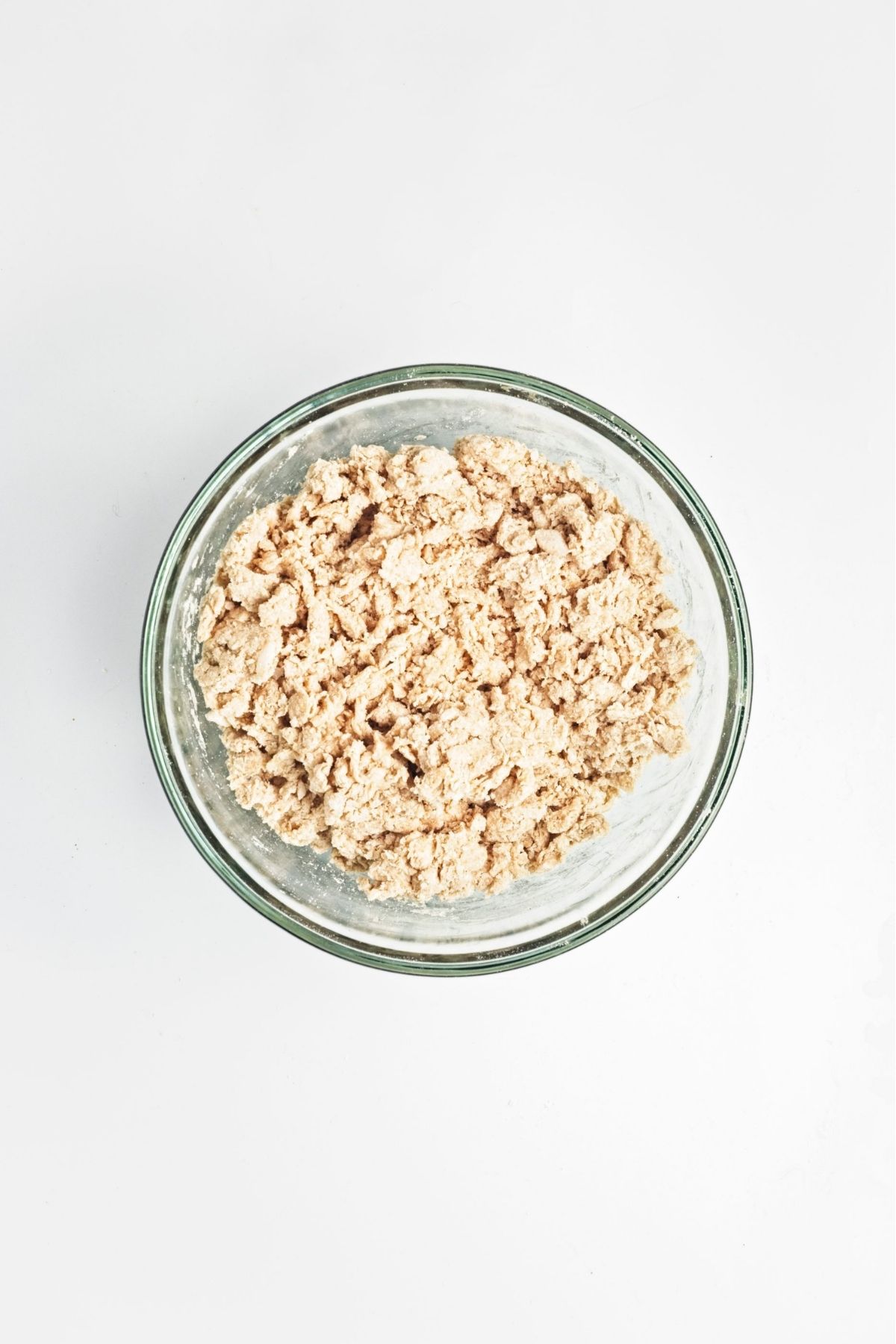 Bowl of crumbly mixed dough before shaping.