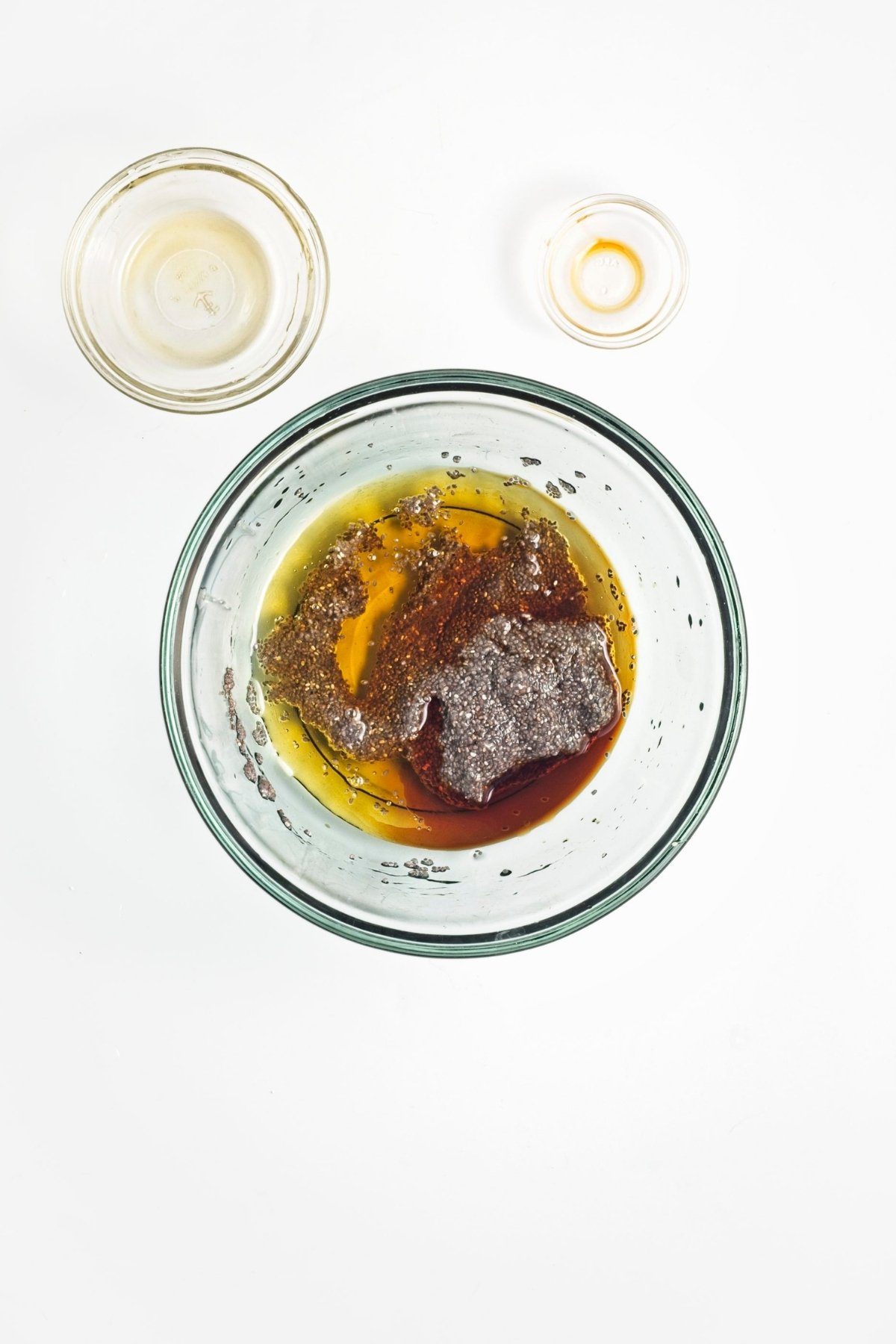 Maple syrup and vanilla poured into the bowl of soaked chia seeds.