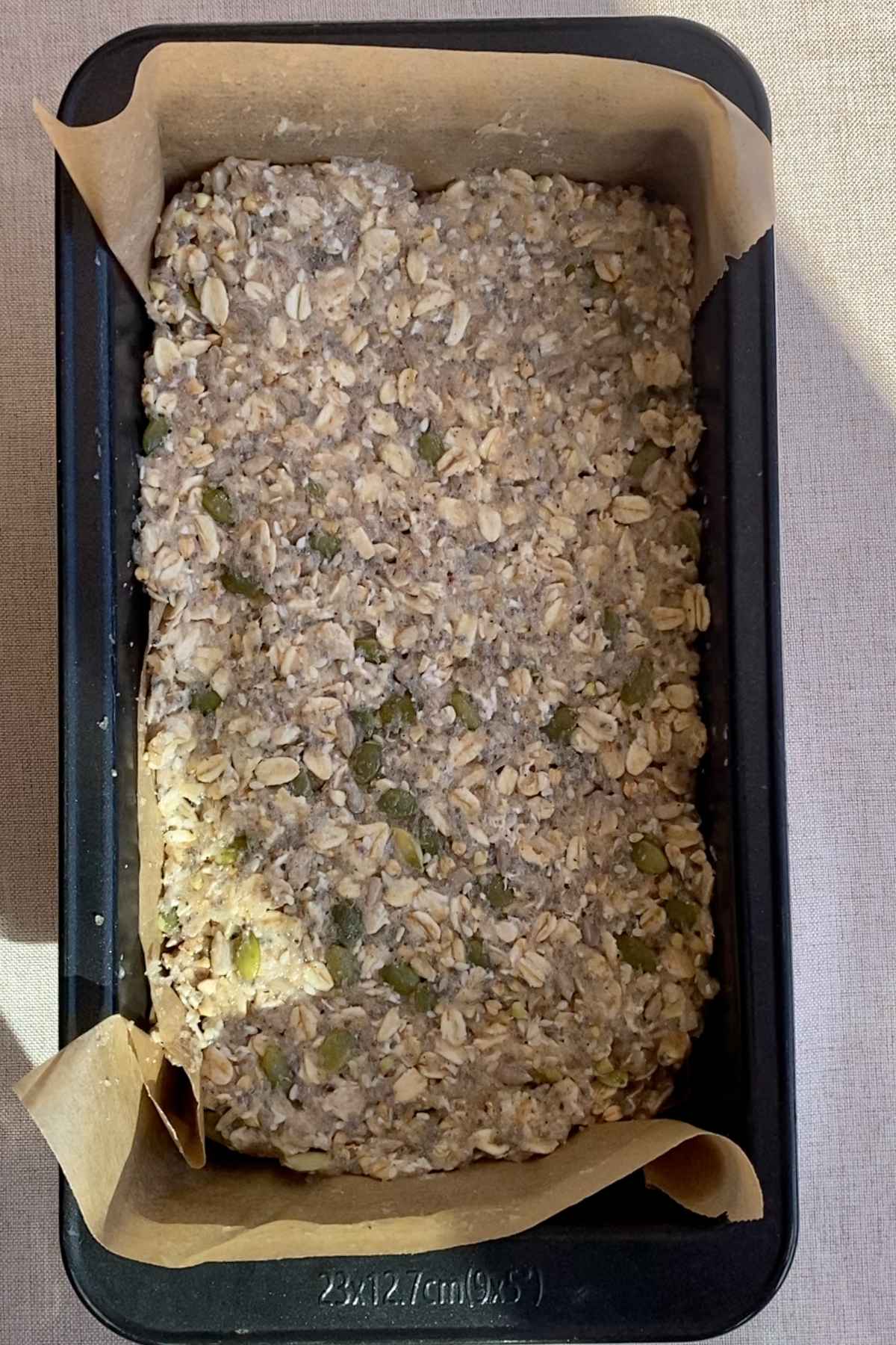 Loaf mixture smoothed out evenly in the baking tin before chilling.