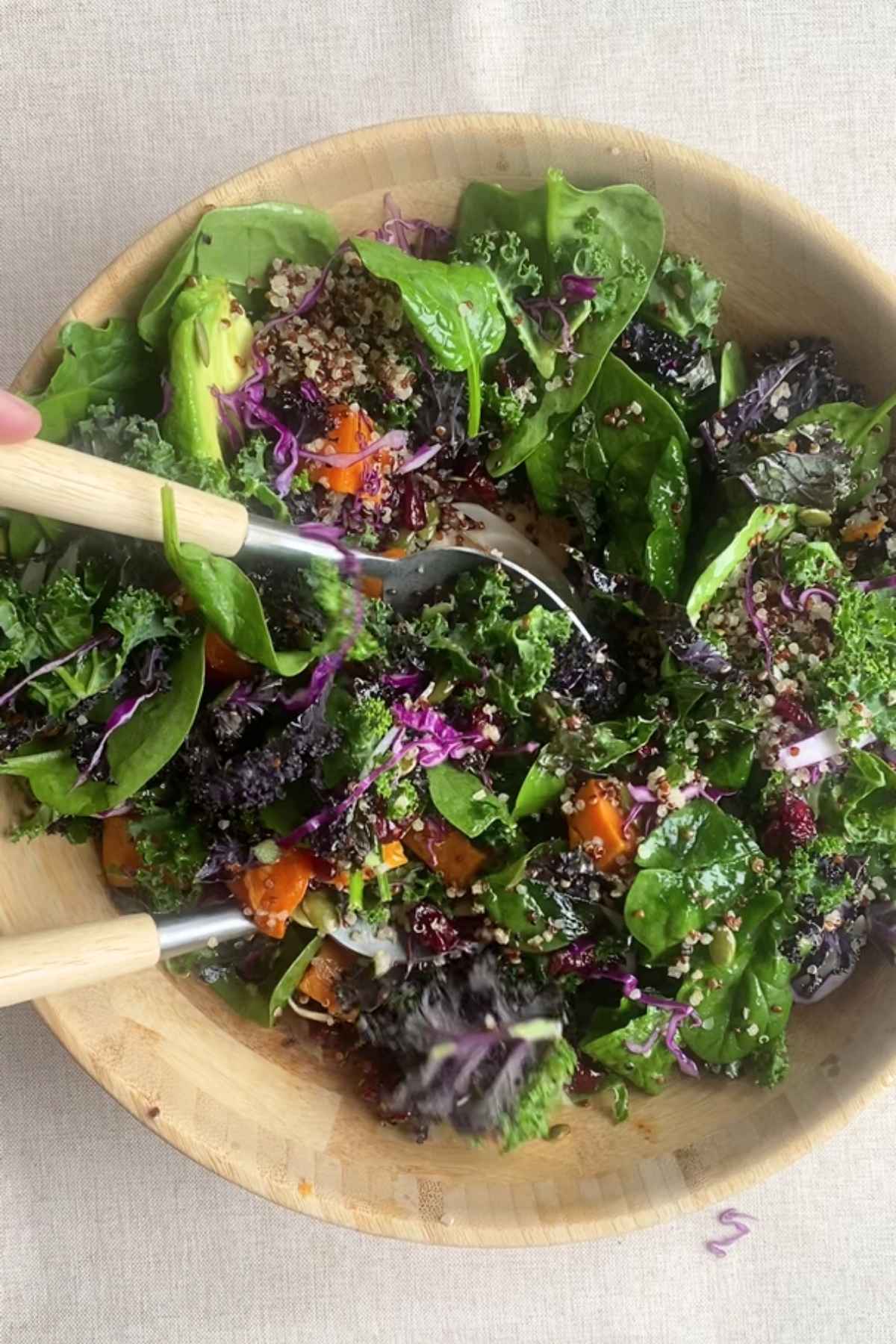 Overhead view of mixed salad with kale, quinoa, sweet potato, and cabbage.