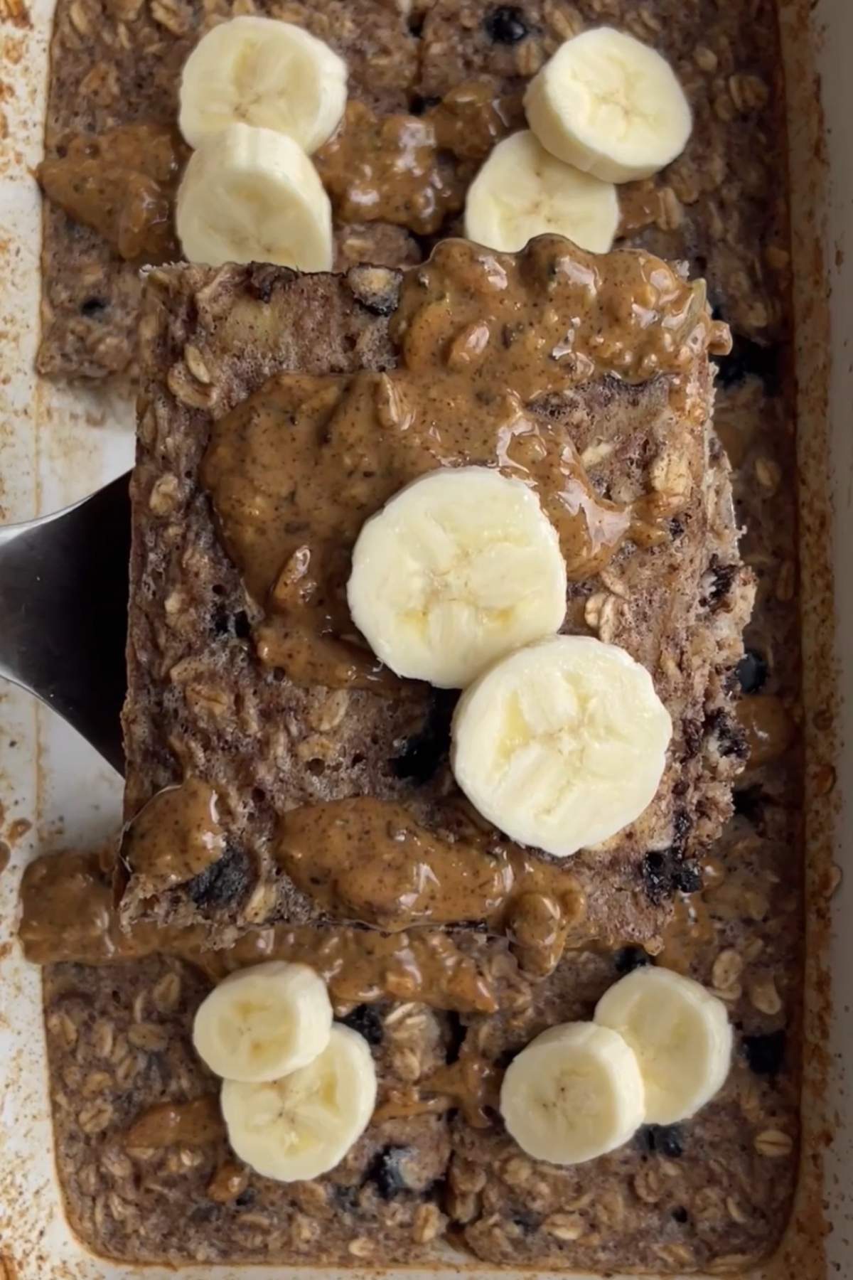 Close-up of banana chocolate chip baked oats with visible oats and melted chocolate.