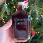 Glass bottle filled with dark gingerbread syrup.
