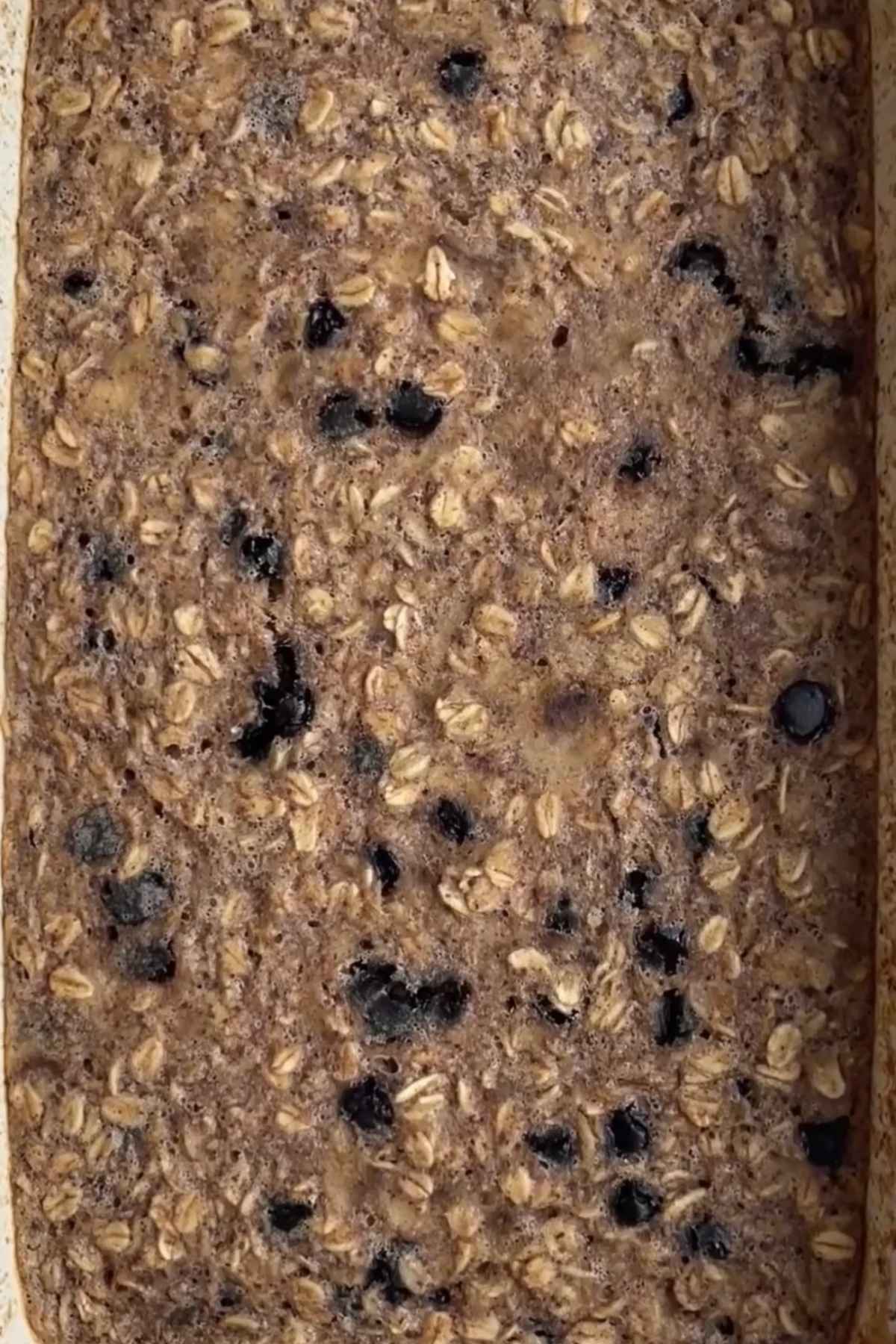 Baked banana chocolate chip oats set and lightly golden in the baking dish.