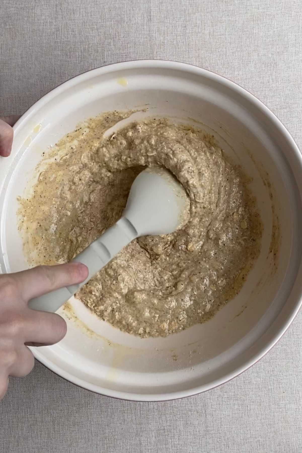 Wet ingredients poured into dry ingredients for blueberry breakfast muffin batter.