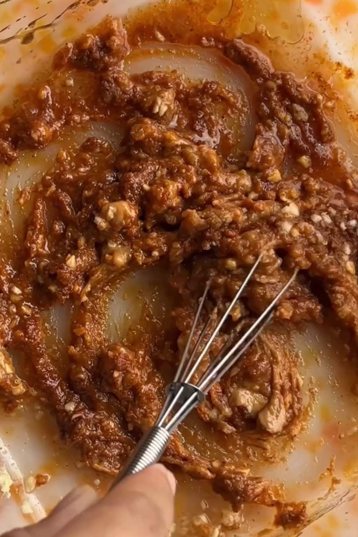Massaman curry paste, miso paste, peanut butter, garlic, ginger, sesame oil, sugar, and vinegar mashed together into a thick curry base in a baking dish.