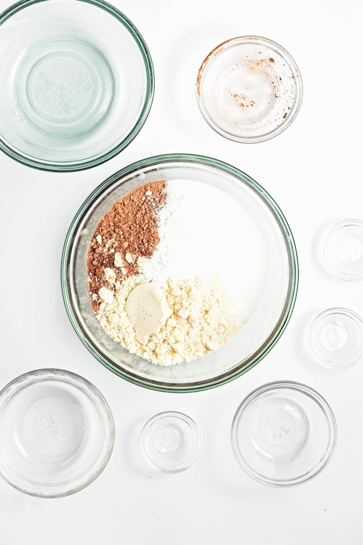 Dry cake ingredients including flour, cocoa powder, and sugar mixed in a bowl.