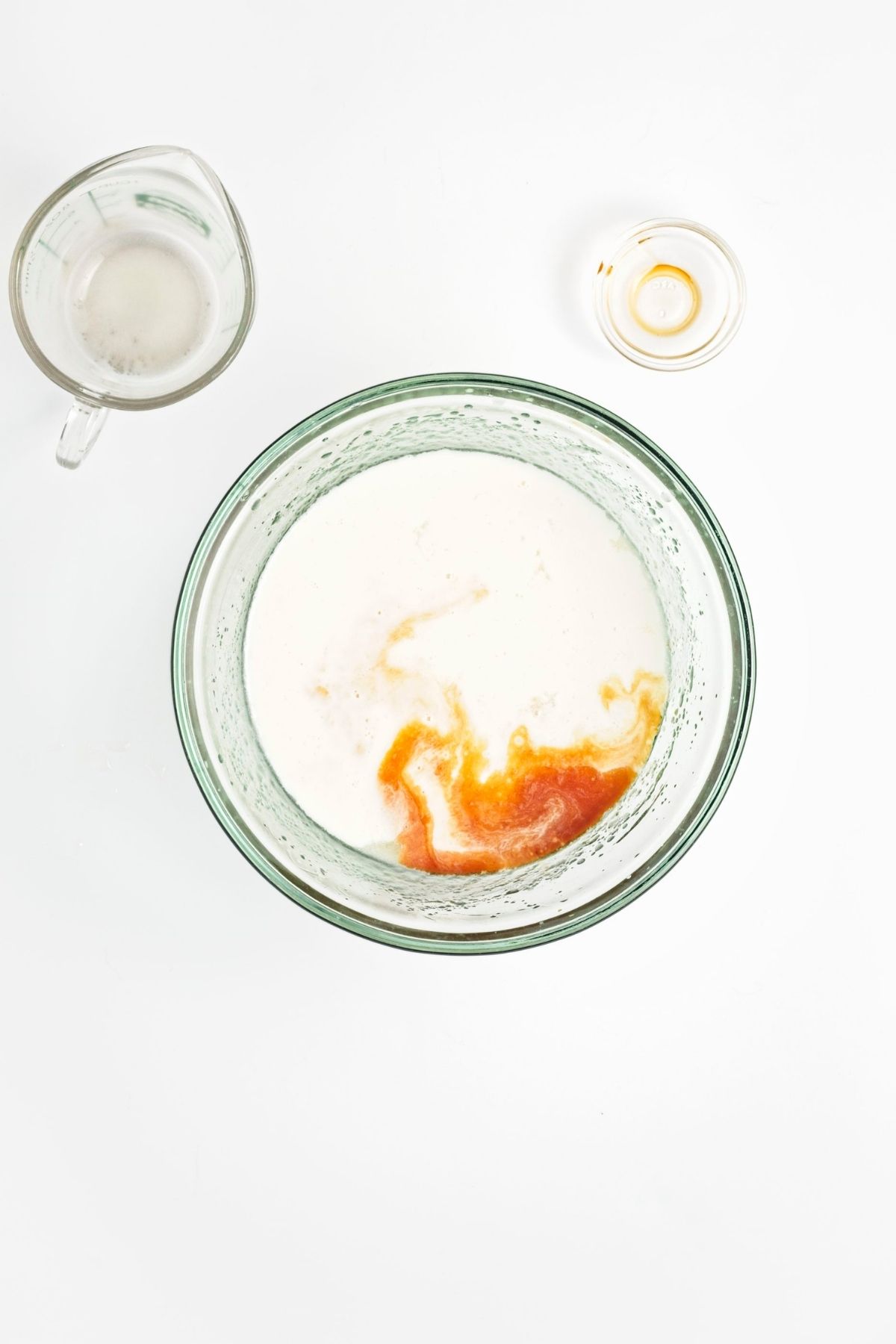 Wet ingredients mixed in a bowl with lemon zest visible.