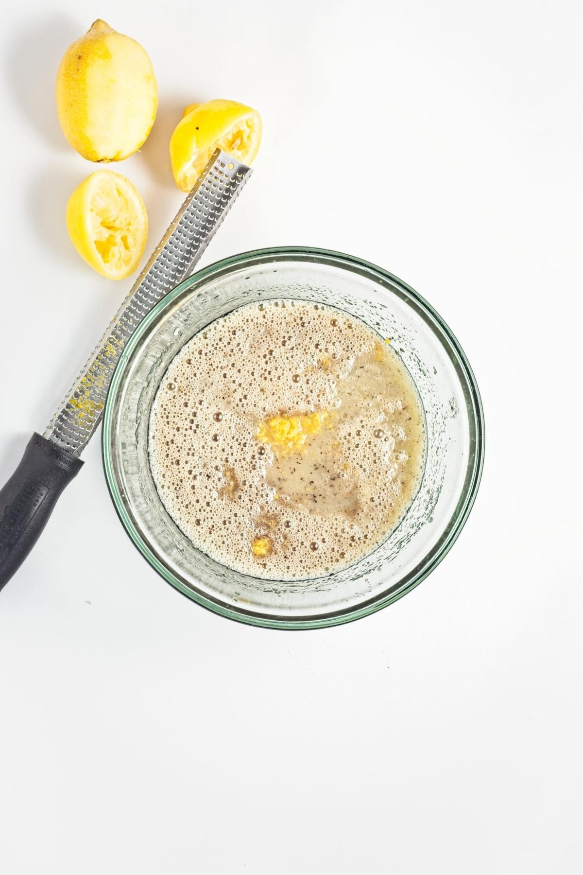 Lemon juice and zest added to the wet batter with visible tea specks.