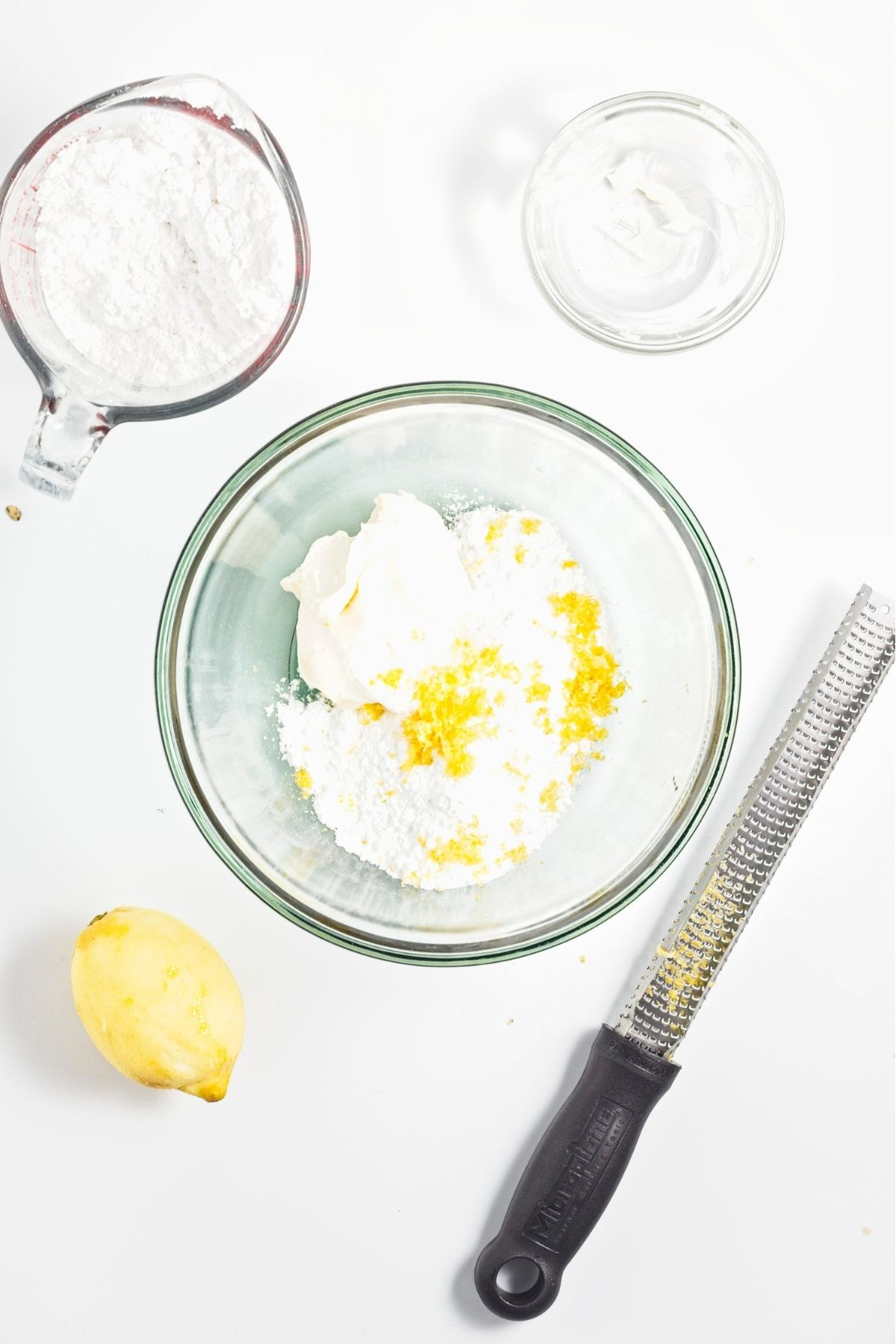 Powdered sugar and vegan butter combined in a bowl for frosting.