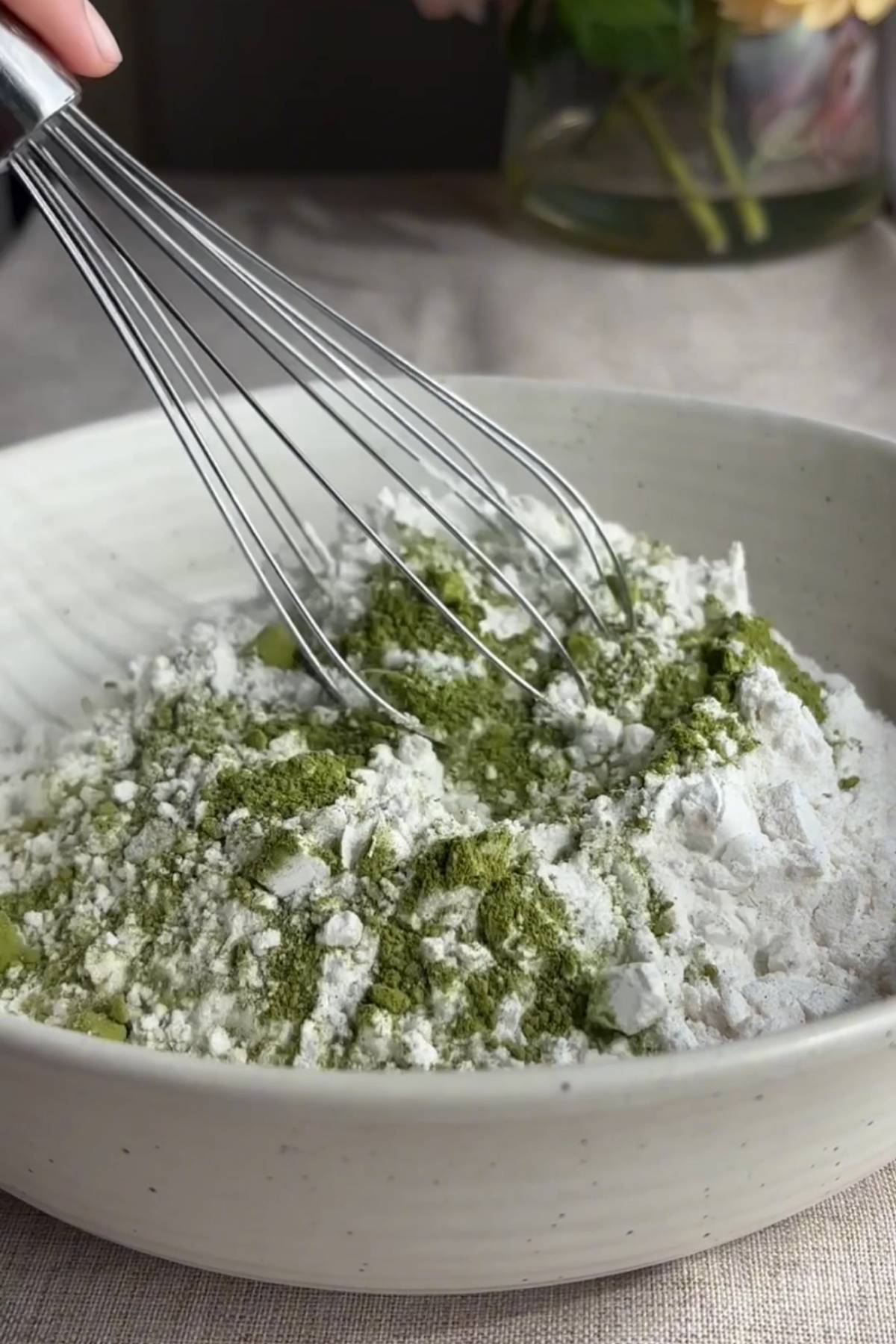 Whisking flour, matcha powder, and salt together in a mixing bowl.