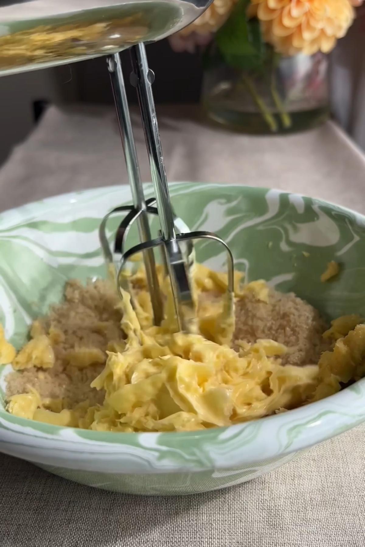 Beating butter and powdered sugar until smooth and creamy in a bowl.