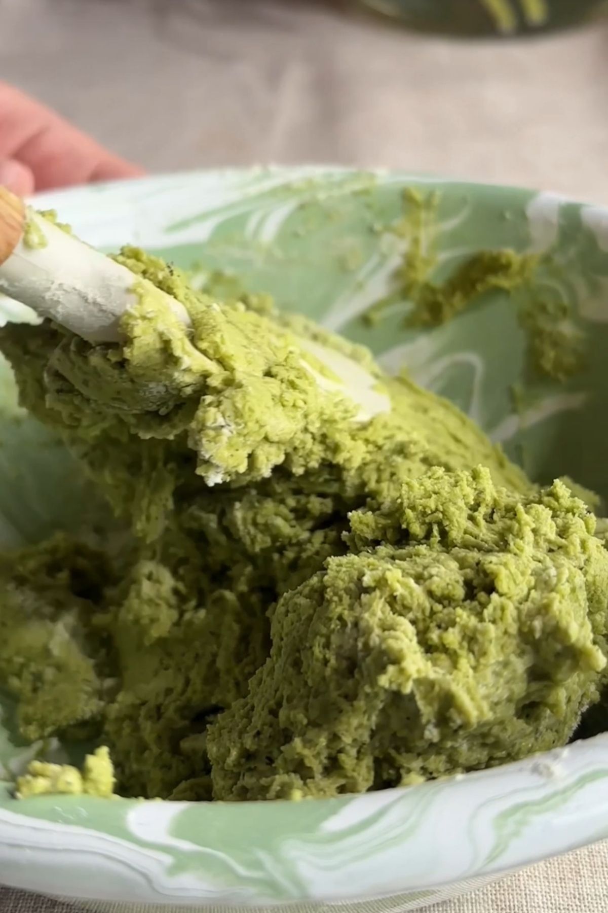Mixing matcha dough until thick and evenly combined.