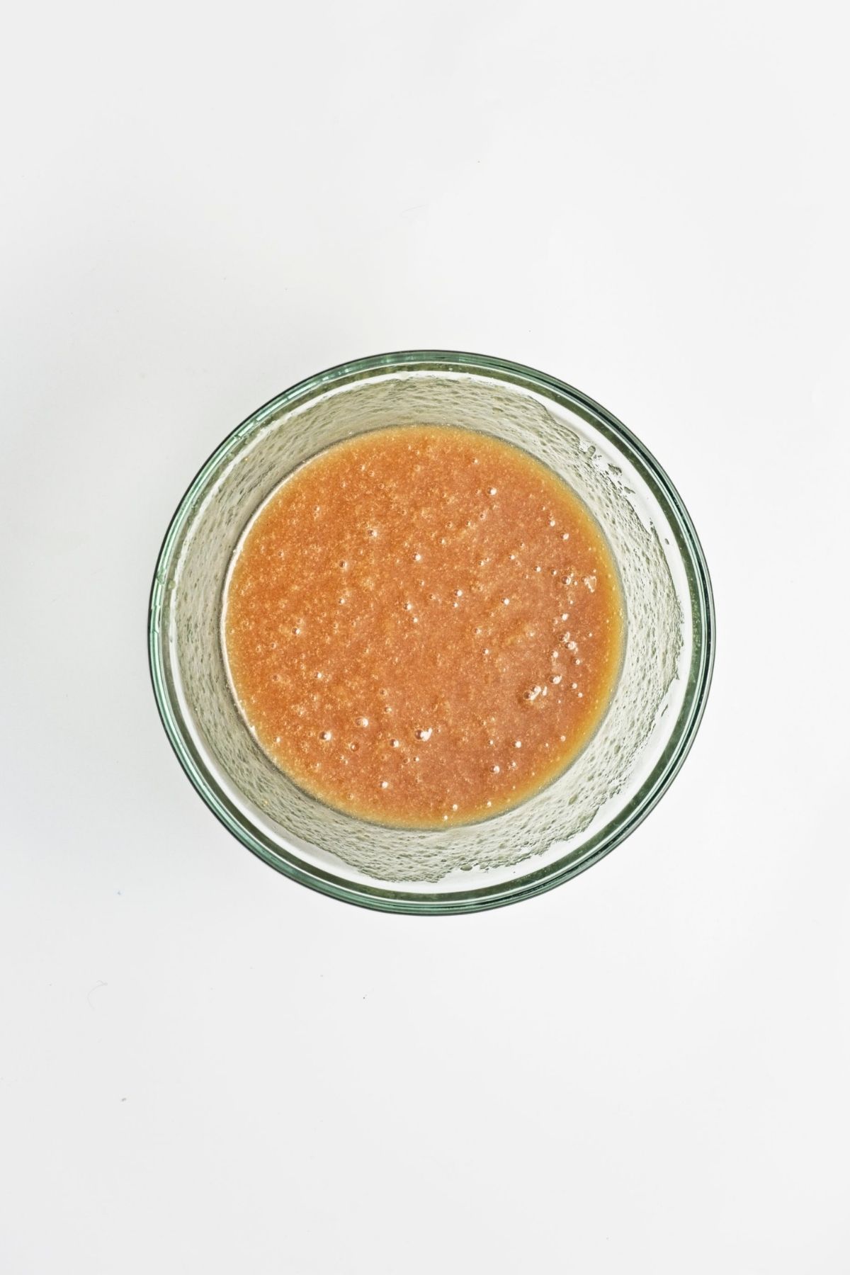 Wet ingredients whisked together in a glass bowl until smooth and fully combined.