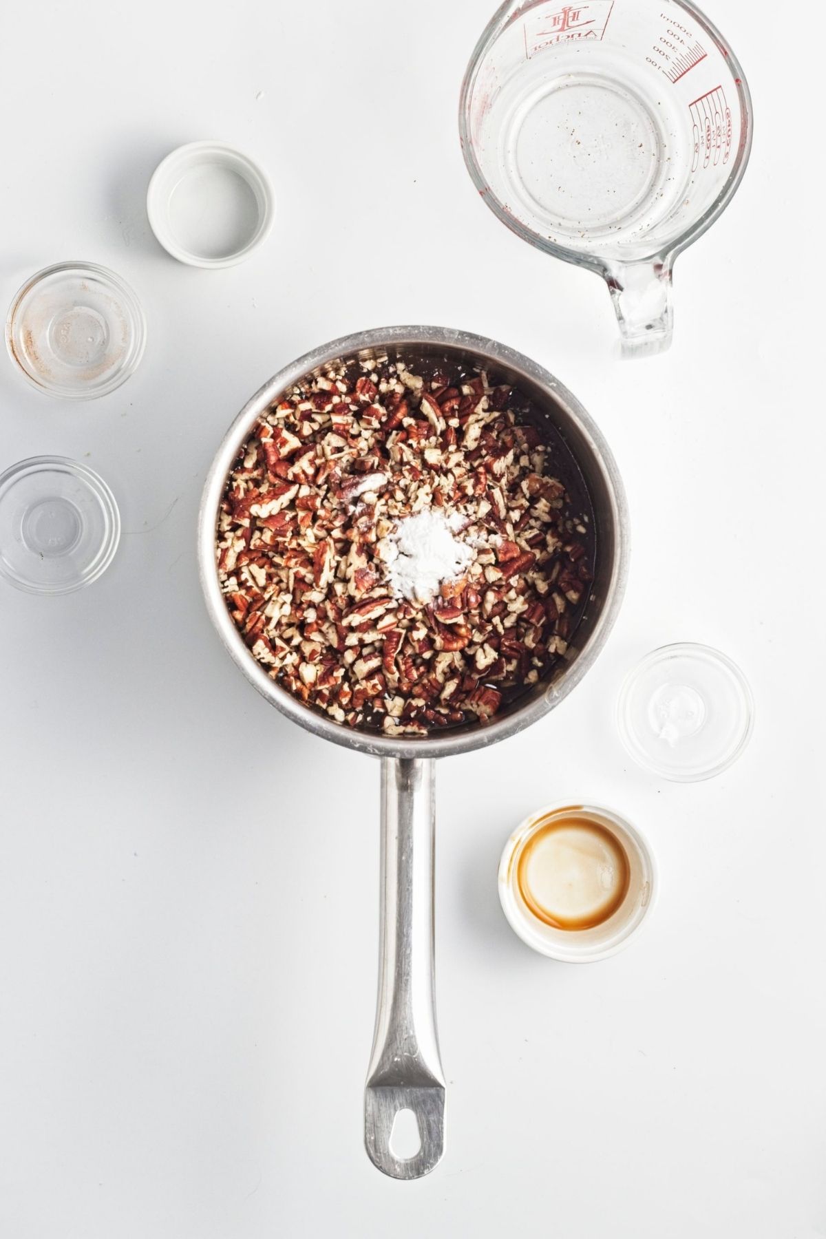 Brown sugar and chopped pecans mixed in a saucepan with a thick, glossy filling.