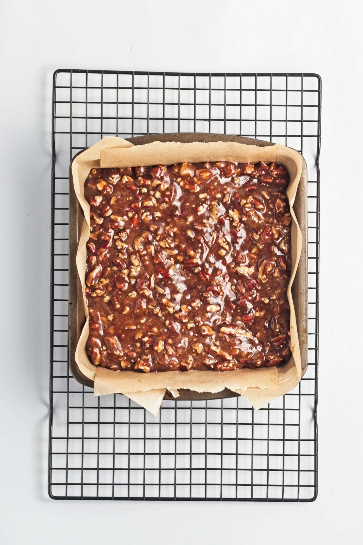 Pecan pie bar filling poured into the pressed dough.