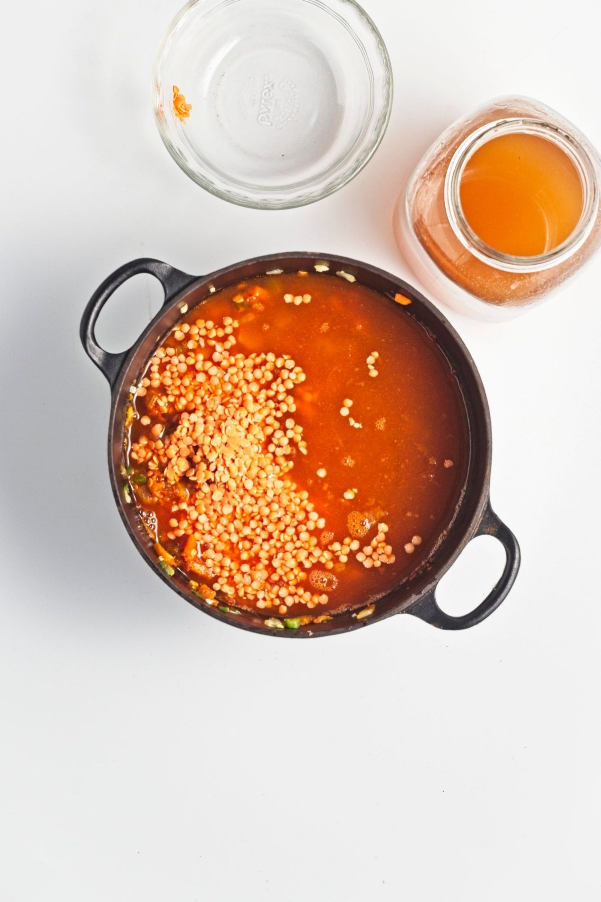 Red lentils and liquid added to the pot with vegetables.