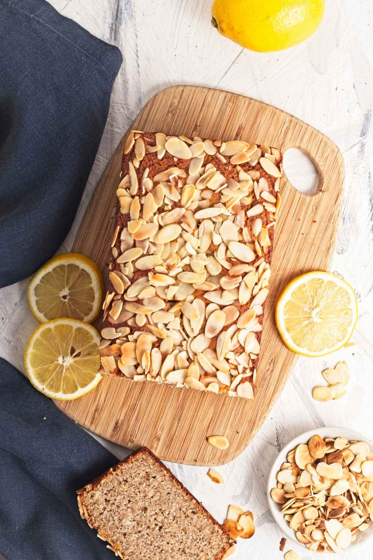 Top view of baked lemon almond loaf covered with sliced almonds.