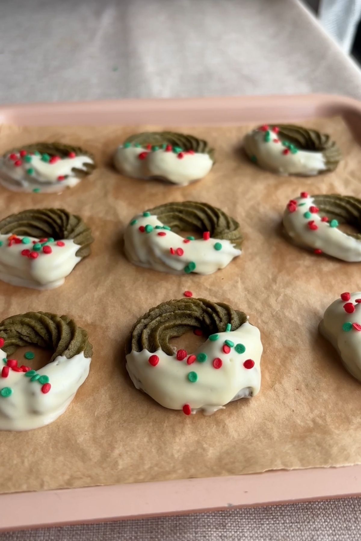 Matcha wreath cookies arranged on parchment paper before serving.