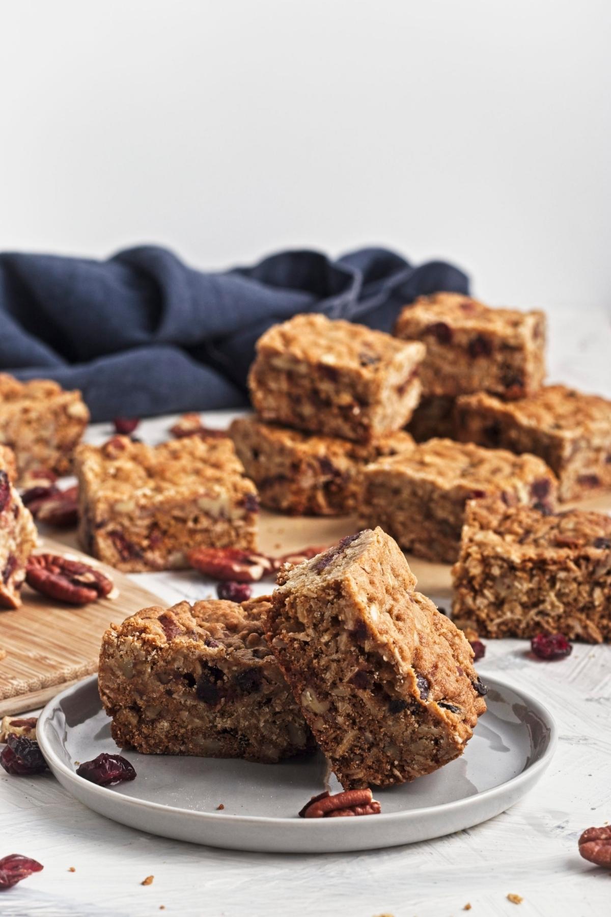 Close-up of sliced oatmeal cookie bars showing chewy texture with visible cranberries and nuts.