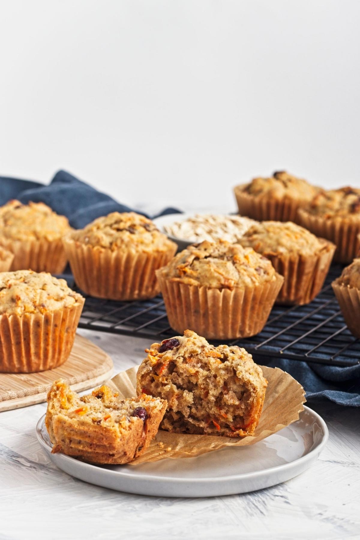 Single vegan carrot cake muffin served on a plate with visible carrot shreds inside