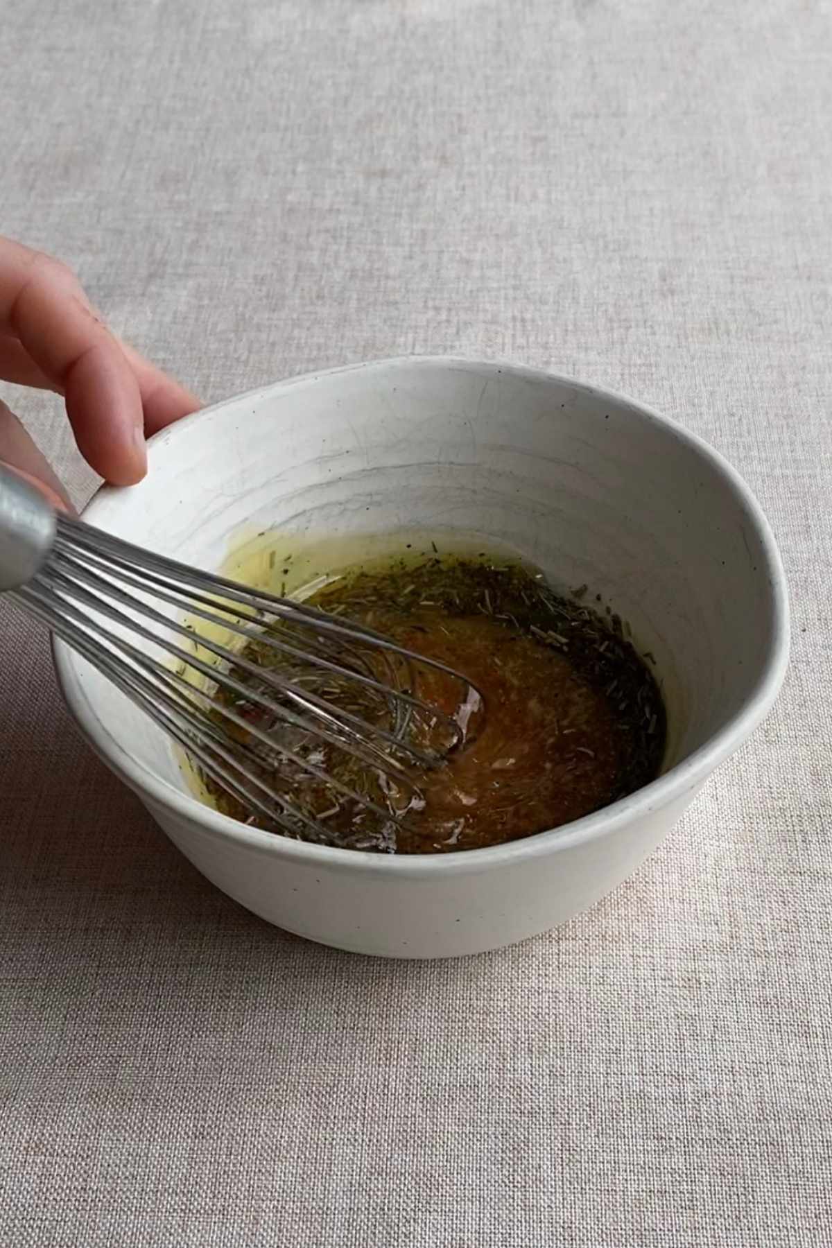 Glaze being whisked in a small bowl until smooth and combined.