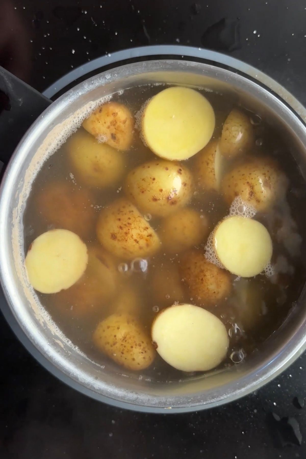 Baby potatoes boiling in salted water until fork-tender