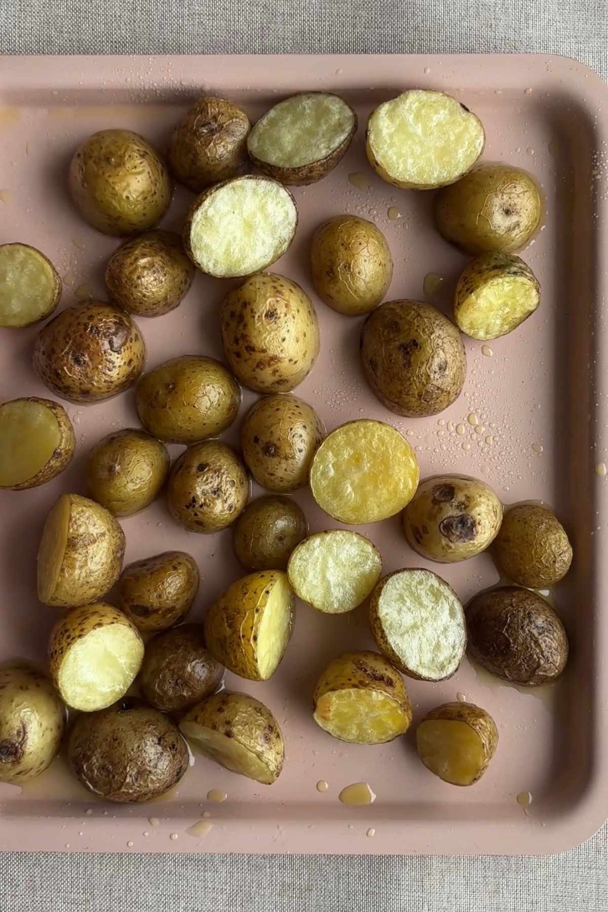 Cooked baby potatoes drained and steaming dry after boiling